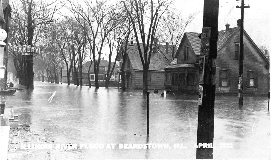 <B>Illinois River Flood</B> at Beardstown, Illinois, in April, 1922 on a street with residences, the Sanitary Bakery, and a barber shop.