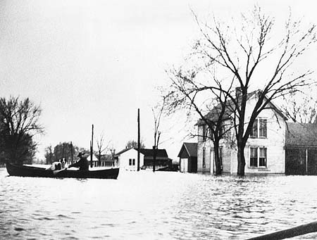 <b>Flood in Liverpool, Illinois</b> circa 1926<br>Looking north from boathouse at Whitehead mound; Teddy Ellsworth house (right), Jim Raker house (center), Summer cabin (left center in distance).<br>Dickson Mounds Museum Collection.