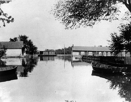 <b>Looking East</b> from the main road in Liverpool, Illinois, 1923.  Warren boathouse is at the right and, at the left, is &quotDud"   Raker's store, which was later moved.<br>Dickson Mound Museum Collection