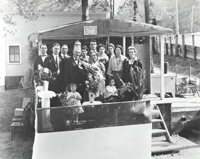 <b>50th Anniversary</b>.<br>Picture of George and Hattie Woodruff's anniversary party on the houseboat (85 feet long, 12 foot wide) they lived in on the river for years before bringing it into town and building on to it.  In 1893, the Woodruffs and their 14 children took the houseboat up river to the Chicago Worlds Fair.<br>Loaned by Donald Woodruff, Joliet, Illinois.