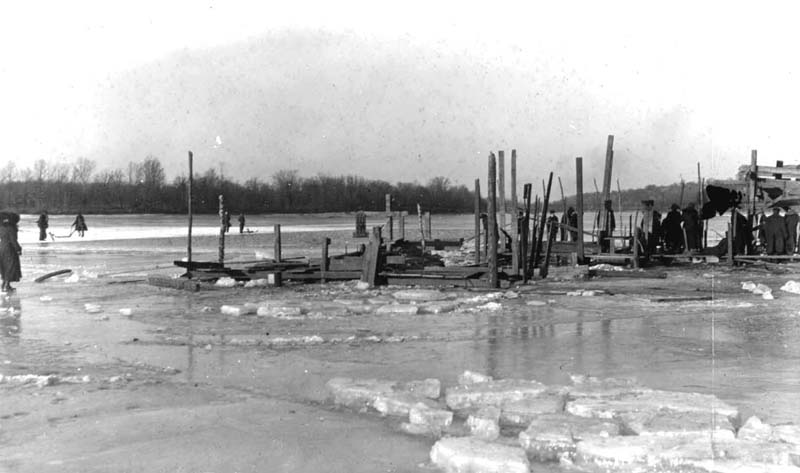 <B>Cutting Ice Up Bay - Bickhans</B><BR> This scene in Quincy Bay, 1900, shows blocks of ice in the foreground and people standing on the uncut ice in the background.