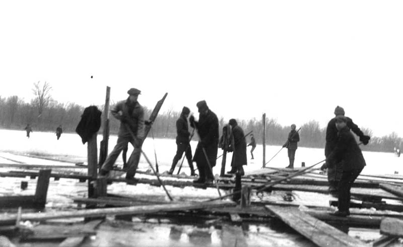 <b>Cutting Ice Up Bay - School Boys</b><BR>This photograph was taken in Quincy Bay circa 1900-1901. The boys are using pikes or poles to push blocks of ice along the channel.