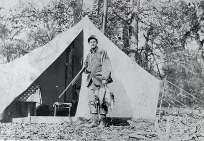<b> Tired and Hungry</b> after a long day of duck hunting, Page Hatch returns to camp, November, 1909
