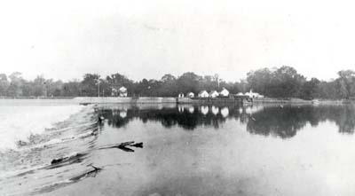 <b>High Water Over the Dam</b> at LaGrange Locks, circa 1903-1920.<p>Caption in the album reads "Thought we could go over top one trip.  Stuck and burned out engine bearing.  Floated helplessly about a mile down stream.  Landed on west side in dark.  Fixed engine next day.  Went through Locks at 4 P.M.  Tied up for night.  Passing ice floe gave us a bad night.  Next morning river was clear and we journeyed on."