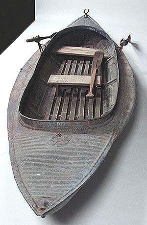 <b>Metal duck boat</b> with flotation compartments, 1894-1923.<br>  The "Bustle" model manufactured by the W.H. Mullins Boat Company of Salem, OH.<br>Elder Family, Osbornville, Illinois<br>galvanized steel<br>12 feet long<br>Illinois State Museum Collection (192.20)<br>Donated by WIlliam Taylor, Decatur, Illinois.