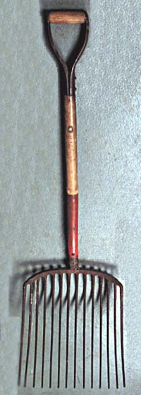 <b>Shell Fork</b>. <br>Wood, metal<br> Musselers used these forks to load shells into and out of the cooking-out vat. Button cutters used them to move shells around in the factory. Used by Marvin "Bud" Gerecke.<br>Meredosia River Museum Collection, Meredosia, Illinois. <br> Donated by Mrs. Marvin Gerecke.