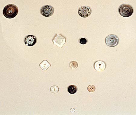<b>Mother of Pearl Buttons</b> cut from fresh-water mussel shells. Natural color and smoked buttons are shown. <br>Jake Wolf Fish Hatchery exhibit, Topeka, Illinois. <br>Gift of Ruby Montgerard.