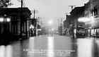 Postcard photograph of a night scene of the business district of Beardstown, Illinois during the flood of 1922