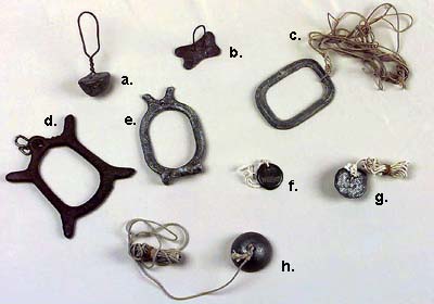 <b>Decoy Anchor Weights</b><br>Illinois State Museum Collection.<br>a.  Coat hanger wire, lead mold (798883)<br>b.  #2 wire and lead form 3/16"<br>c.  One side flat, peaked on the other (1968.12, 798884.2)<br>d.  H.L. Rawlins, Thomson, Illinois, Pat pen 715746, 5"(1995.143)<br>e.  IDEAL decoy weight, 5" (1968.4, 798884).<br>f.  WEEKS weight, 1 1/4" x 3/16"<br>g.  Homemade lead weight with bent nail loops (798882)<br>h.  (1968.12, 798882{3})