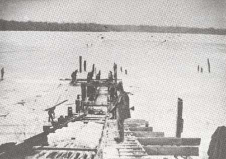 <b>Harvesting Ice</b>.  Blocks of ice were hauled up the slide with ice hooks from the bay to the ice house.