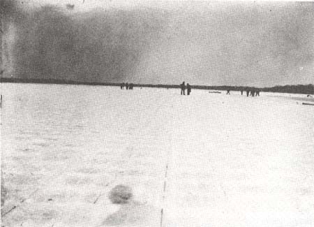 <b>Cutting Ice from the River</b><br>The first step in ice cutting was to score the ice in a grid. Horse-powered grid cutters were replaced by gas-powered saws. The grid can be seen in the foreground.
