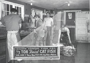 <b>Close-up of Sign Announcing Fish Fry in Bath</b><BR>It is not known which fish company this photograph depicts, but on the wall in the corner is the small flyer advertising the Eighth Annual Bath Fish Fry, which would date to 1919.