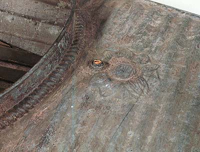 <b>Detail of Metal Duck Boat</b> with flotation compartments, <br>  W. H. Mullins Boat Company, Salem OH, 1893-1924.<br>Elder family, Osbornville, Illinois<br>Galvanized Steel<br>12 feet long<br>Illinois State Museum Collection  (1992.20)<br>Donated by William Taylor, Decatur, Illinois.<p>Note raised rope-like design and raised floral decoration.