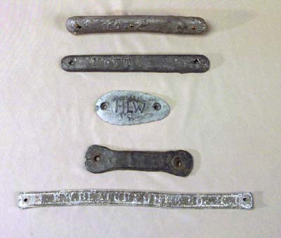 <b>Decoy Weights</b><br>Weights were nailed into groves on the lower surface of wooden decoys so that the decoy would float in the water upright and at the proper depth.<p>  From top to bottom:  2 5" weights made by J. F. Mott (1968.12,798885); 2 1/2" domed oval (798925); 4" homemade weight; 8" weight from an Elliston decoy by E. W. Blatchforer Co., Chicago.