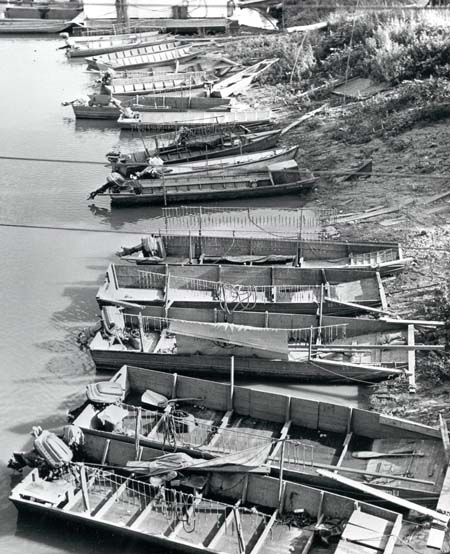 <b>Musseling Boats</b>.<br>Johnboats equipped with crowfoot bars and 