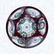 Red OverlayFranceBaccarat, circa 1845-55Diameter: 7.3 cm (2 7/8 inches)(702294)Single overlay of translucent ruby red, enclosing a garland millefiori design comprised of seven circlets; lower sides cut with twelve oval printies; upper sides cut witih six circular printies, one on top