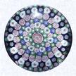 Clichy Rose Close Concentric MillefioriFranceClichy, gilded base dated 1845Diameter: 7.3 cm (2 7/8 inches)(702323)Close concentric millefiori with six rings of millefiori canes in deep purple, green, pink, and white around a pink Clichy rose; fourth ring contains twenty-one pink Clichy roses; fifth ring contains thirteen white Clichy roses; pedestal column of blue and white staves; gilded metal foot (see side view and QTVR) engraved 