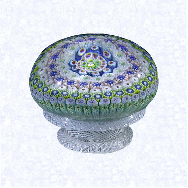 <B>Millefiori on Lattice Pedestal Base<BR>France<BR>Saint Louis (signed), dated 1848</B><BR>Diameter: 8 cm (3 1/8 inches)<BR>(702295)<BR><BR>Close concentric millefiori with nine concentric rings of multicolored millefiori canes, including one black signed and dated cane inscribed 